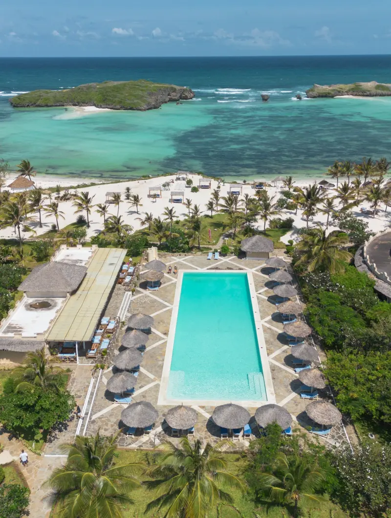 The pool and gardens of 7 Islands Resort from above