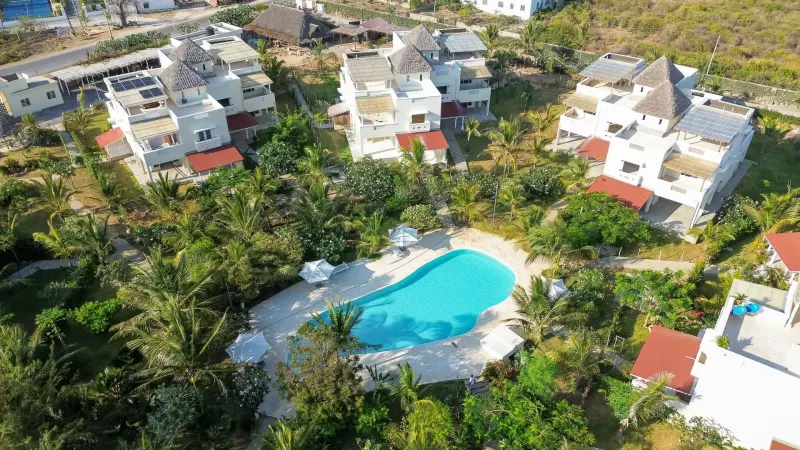 The white villas and pools of Paparemo Village from the air