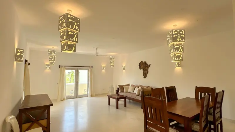 The open-plan living and dining room with brass lanterns