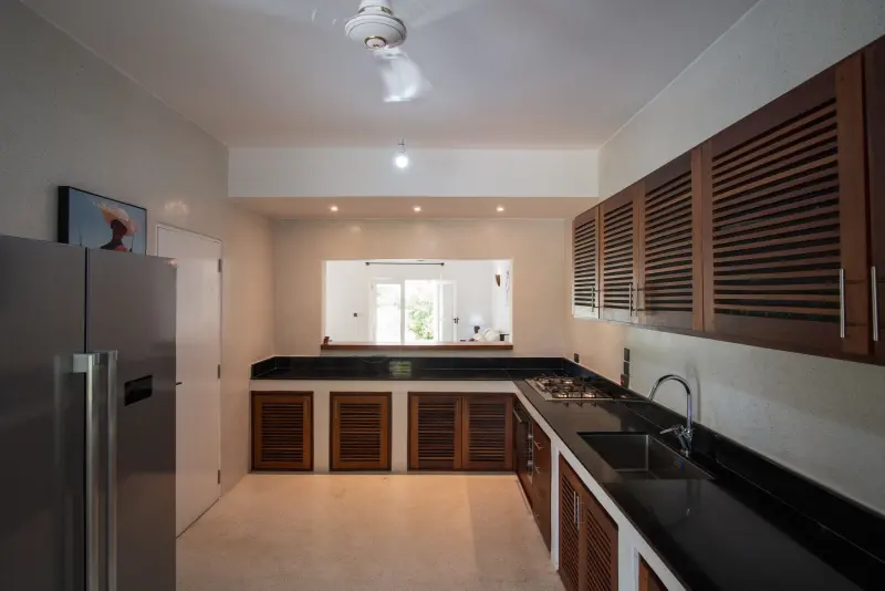 The fitted kitchen with dark wood cabinets