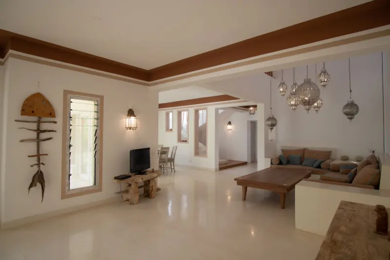 The open living room with carved ceiling beams