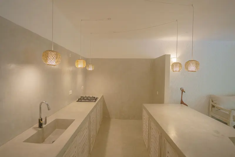The kitchen with a long white counter