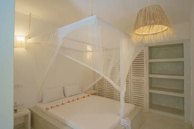 A bedroom with built-in shelves