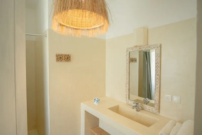 A vanity under a woven pendant